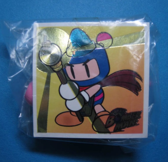This card shows his colour scheme. In the pack is a football/soccerball-wielding Bomberman.